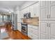 Bright kitchen with stainless steel appliances, white cabinetry, and a view to the breakfast area at 728 Elizabeth Dr., Murrells Inlet, SC 29576