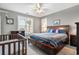 Spacious main bedroom with ceiling fan, picture window, and ensuite bathroom at 728 Elizabeth Dr., Murrells Inlet, SC 29576