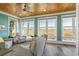 Bright sun room with tongue and groove ceiling, tile floor, and large windows with marsh views at 728 Elizabeth Dr., Murrells Inlet, SC 29576