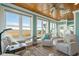 Bright sun room with tongue and groove ceiling, tile floor, and large windows with marsh views at 728 Elizabeth Dr., Murrells Inlet, SC 29576