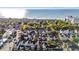 Scenic aerial view of a coastal neighborhood with homes nestled among trees and the ocean waves in the background at 7809 Monarch Dr., Myrtle Beach, SC 29572