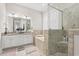 Bathroom featuring dual vanities, soaking tub, tiled shower with glass door, and neutral tile flooring at 7809 Monarch Dr., Myrtle Beach, SC 29572
