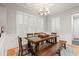 Elegant dining room featuring a wooden table, bench seating, and chandelier lighting at 7809 Monarch Dr., Myrtle Beach, SC 29572