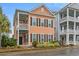 Inviting two-story home with a balcony, black shutters, well-manicured landscaping, and beautiful curb appeal at 7809 Monarch Dr., Myrtle Beach, SC 29572