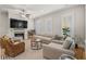 Bright living room with a fireplace, ceiling fan, and neutral-toned furniture at 7809 Monarch Dr., Myrtle Beach, SC 29572
