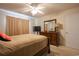 Spacious main bedroom with neutral carpet, ceiling fan, closet, and wood furniture at 793 Drawbridge Dr., Conway, SC 29526