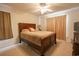 Comfortable main bedroom with neutral carpet, ceiling fan, and closet with natural lighting at 793 Drawbridge Dr., Conway, SC 29526