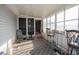 Enclosed sunroom with screen door, white siding, and a patterned grey rug at 793 Drawbridge Dr., Conway, SC 29526