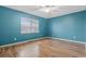 Bright bedroom with wood floors, a ceiling fan, and a large window at 810 Finger Lake Dr., Myrtle Beach, SC 29588