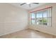 Bright bedroom featuring a ceiling fan and a large window offering pleasant neighborhood views at 810 Finger Lake Dr., Myrtle Beach, SC 29588