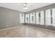 Serene bedroom featuring neutral walls, multiple windows with sheer curtains and tiled floors at 810 Finger Lake Dr., Myrtle Beach, SC 29588