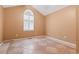This bedroom has tile flooring and a large window with blinds at 810 Finger Lake Dr., Myrtle Beach, SC 29588