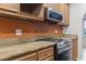 Kitchen close up featuring granite countertops, stainless steel appliances and wood cabinets at 810 Finger Lake Dr., Myrtle Beach, SC 29588