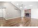 Bright living room with high ceilings, wood floors, a ceiling fan, and a cozy fireplace at 810 Finger Lake Dr., Myrtle Beach, SC 29588