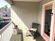 Cozy balcony with a wicker chair, side table, and views of the surrounding neighborhood at 820 9Th Ave. S, North Myrtle Beach, SC 29582