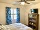 Cozy bedroom with ceiling fan, TV, and coastal-themed decor and curtains at 820 9Th Ave. S, North Myrtle Beach, SC 29582