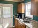 Kitchen features a stainless steel sink, wood cabinets, and a window with natural light at 820 9Th Ave. S, North Myrtle Beach, SC 29582