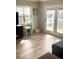 Sunlit living room with access to the outside features wood-look flooring and neutral decor at 820 9Th Ave. S, North Myrtle Beach, SC 29582