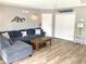 Inviting living room features wood-look flooring, beach-themed decor, and a comfortable sectional sofa at 820 9Th Ave. S, North Myrtle Beach, SC 29582