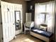 Bright home office featuring a blue tufted bench, rolltop desk, and natural light at 820 9Th Ave. S, North Myrtle Beach, SC 29582
