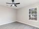 Bedroom featuring gray vinyl flooring, a ceiling fan, and a large window at 822 Highway 90, Conway, SC 29526