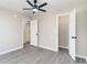 This bedroom offers neutral paint and wood-look flooring plus a lighted ceiling fan at 822 Highway 90, Conway, SC 29526