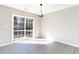 A dining room features wood-look floors, a sliding glass door, and a chandelier at 822 Highway 90, Conway, SC 29526