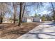 Ranch-style home featuring classic architecture and an extended driveway leading to an attached garage at 822 Highway 90, Conway, SC 29526
