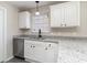 Kitchen features granite countertops, white cabinets, stainless appliances, and ample storage at 822 Highway 90, Conway, SC 29526
