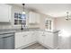 Bright kitchen features white cabinets, granite countertops, and a stainless steel dishwasher at 822 Highway 90, Conway, SC 29526