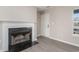 Cozy living room features a decorative fireplace, neutral paint, durable floors, and lots of natural light at 822 Highway 90, Conway, SC 29526