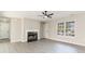 Bright living room features a fireplace, ceiling fan, lots of natural light, and neutral-toned walls at 822 Highway 90, Conway, SC 29526