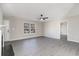 Spacious living room with fireplace, fan, neutral colors, and luxury vinyl floors offer easy transition into other rooms at 822 Highway 90, Conway, SC 29526