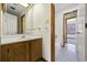 Bright bathroom featuring a vanity with solid surface countertop, wooden cabinets and tile floors at 830 44Th Ave. N # L2, Myrtle Beach, SC 29577