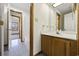 Bathroom featuring a vanity with solid surface countertop, wooden cabinets and tile floors at 830 44Th Ave. N # L2, Myrtle Beach, SC 29577