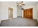 Bright bedroom with gray carpet, ceiling fan, closet, and ensuite bathroom at 830 44Th Ave. N # L2, Myrtle Beach, SC 29577