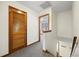 Hallway with gray carpet, white walls, and wood trim, leading to other rooms at 830 44Th Ave. N # L2, Myrtle Beach, SC 29577