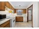 Efficient kitchen with white appliances, wood cabinets, and tile flooring, offering functionality at 830 44Th Ave. N # L2, Myrtle Beach, SC 29577