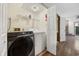 Laundry room with washer, dryer, wire shelving and access to another room at 830 44Th Ave. N # L2, Myrtle Beach, SC 29577