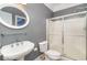 Bathroom with a pedestal sink, a frosted glass shower, and gray walls in a well-lit space at 898 Bluffview Dr., Myrtle Beach, SC 29579