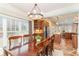 Well-lit dining room adjacent to kitchen has a large window and a statement chandelier at 898 Bluffview Dr., Myrtle Beach, SC 29579