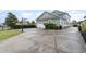 Expansive concrete driveway featuring a basketball hoop leading to a two car garage at 898 Bluffview Dr., Myrtle Beach, SC 29579
