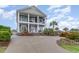 Stunning two-story home boasts dual porches, white columns, and a meticulously landscaped yard at 898 Bluffview Dr., Myrtle Beach, SC 29579