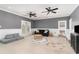 Spacious living room with dark gray walls, wainscoting, and multiple ceiling fans at 898 Bluffview Dr., Myrtle Beach, SC 29579