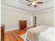 Bedroom featuring hardwood floors, tray ceilings, a ceiling fan, and classic wood furniture at 898 Bluffview Dr., Myrtle Beach, SC 29579
