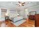 Primary bedroom with natural light, tray ceilings, hardwood floors, and neutral tones creating a serene atmosphere at 898 Bluffview Dr., Myrtle Beach, SC 29579
