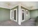 Green-painted screened porch featuring gray wood floors and a ceiling fan at 898 Bluffview Dr., Myrtle Beach, SC 29579