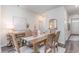 Dining area with a rustic wooden table, decorative accents, and contemporary artwork, showcasing neutral walls at 906 Ireland Dr., Longs, SC 29568