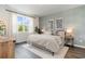 Relaxing main bedroom featuring a large window, stylish accent wall, and a comfortable bed at 906 Ireland Dr., Longs, SC 29568