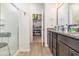 Bathroom featuring a walk-in shower, vanity with dark wood cabinets and a granite countertop at 909 Witherbee Way, Little River, SC 29566